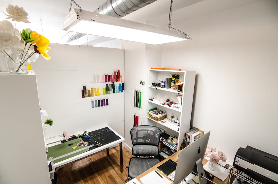 Elegant and organized creative workspace featuring design materials and office equipment, perfect for innovative work